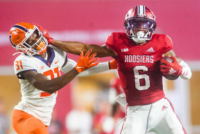 Indiana's Cam Camper (6) stiff arms Illinois' Devon Witherspoon (31) during the Indiana versus Illinois football game at Memorial Stadium on Friday, Sept. 2, 2022.